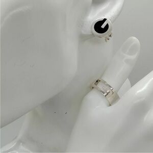 Gucci silver ring and pierced black and silver earrings.